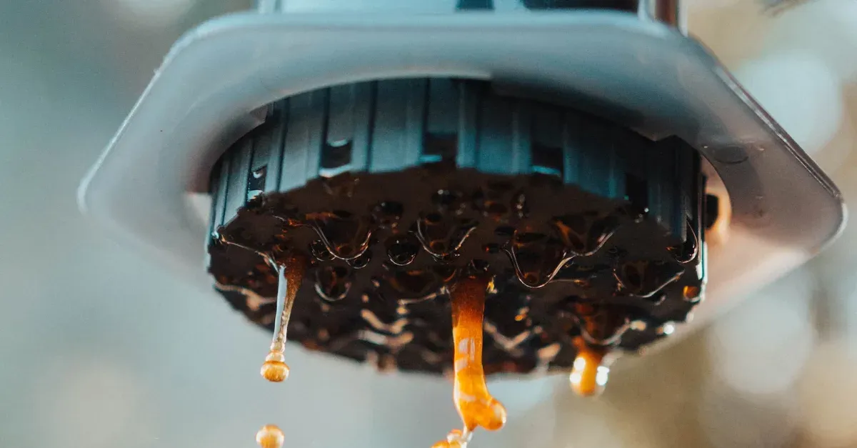 Coffee being pushed through an Aeropress