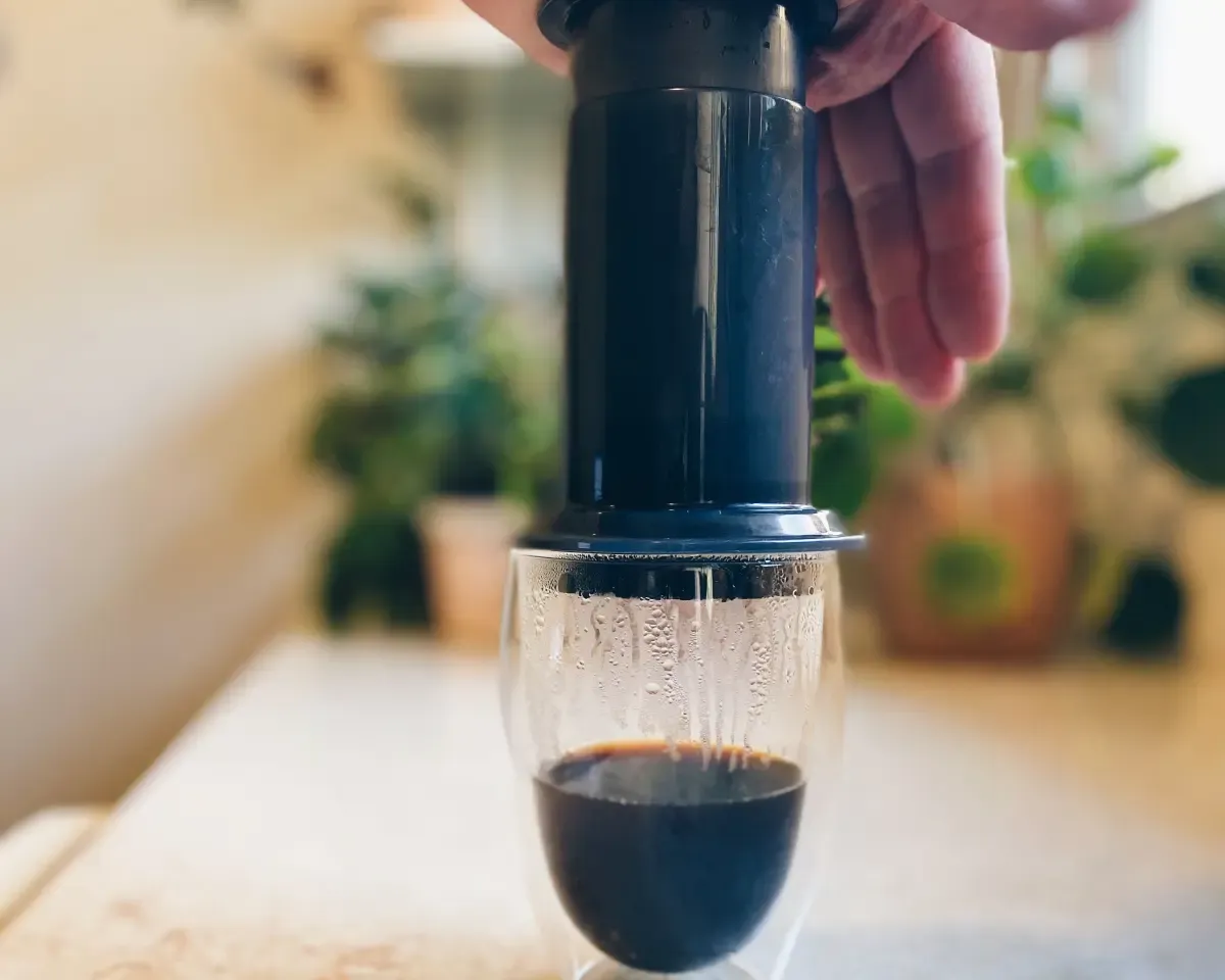 Aeropress brewing coffee beans into a bodum cup