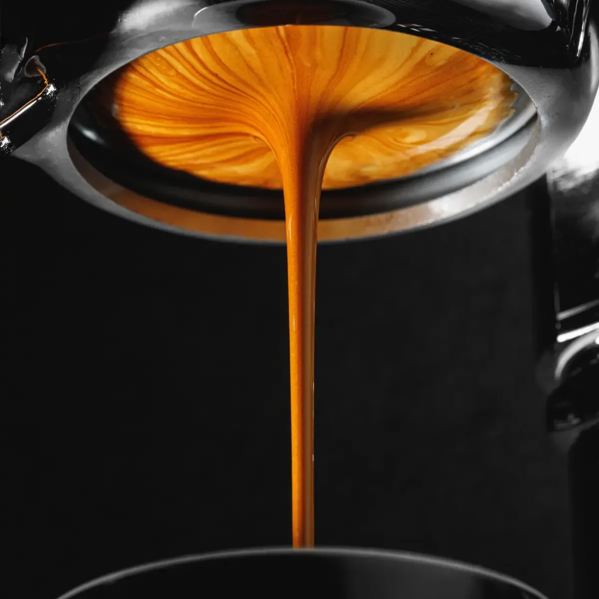 Beautiful caramel looking espresso pouring out of the machine
