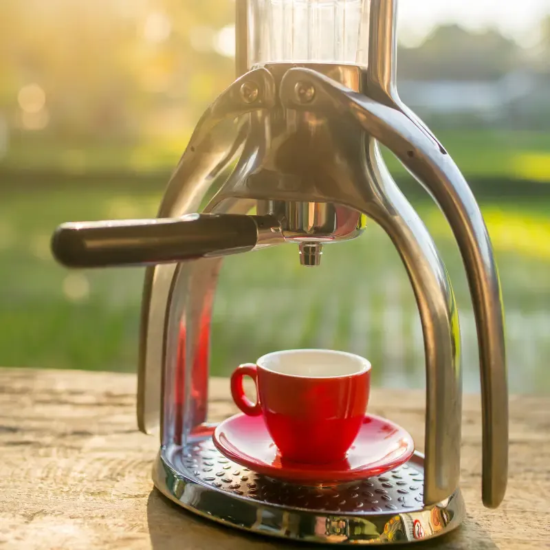 manual espresso maker with a red espresso cup