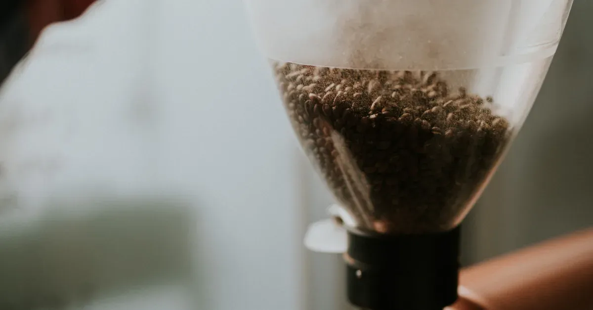 Grinding coffee beans in a grinder at home
