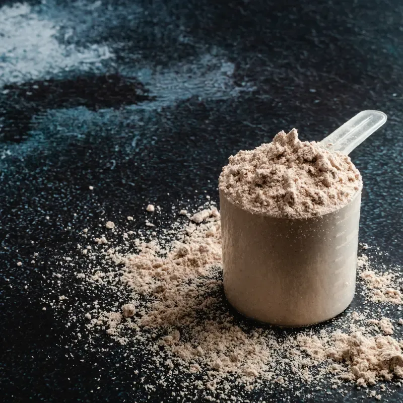 A scoop with powder on a table