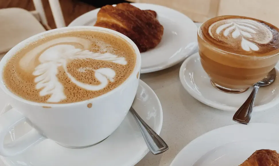 A cup of latte and a cup of cortado