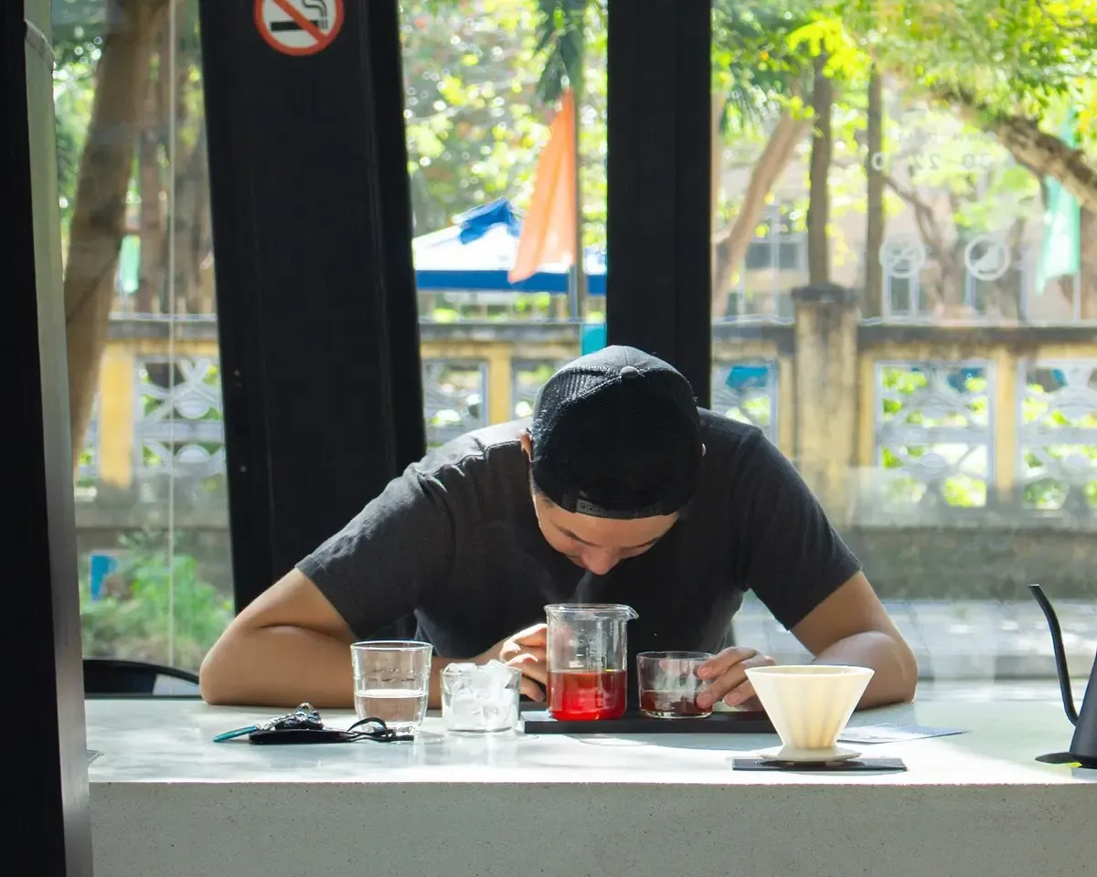Young man enjoying the smell of his fresh dripped coffee