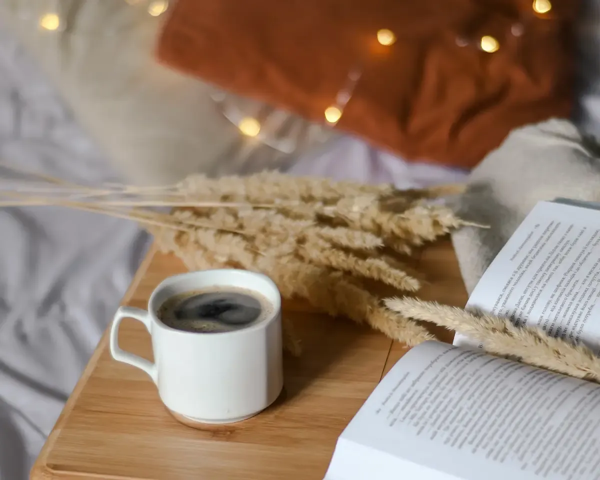 Cup of coffee on a bedtable