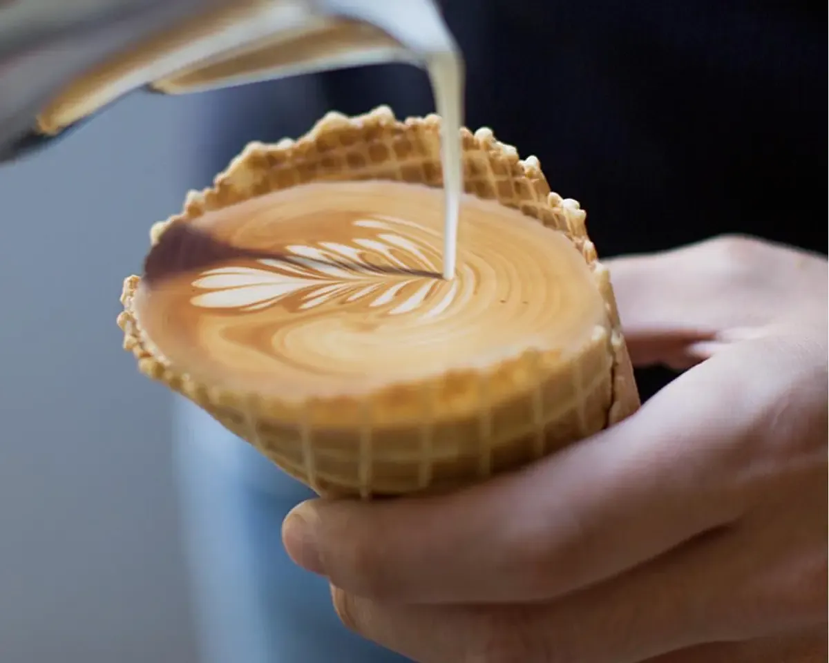 Coffee Latte being poured into a waffle cone
