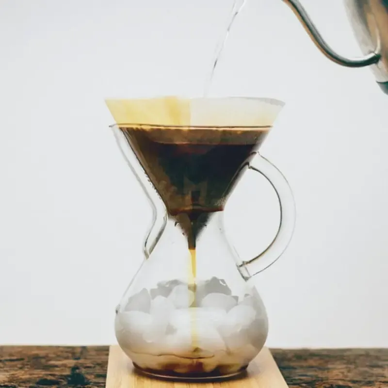 Pouring into a pour-over maker with ice on the bottom