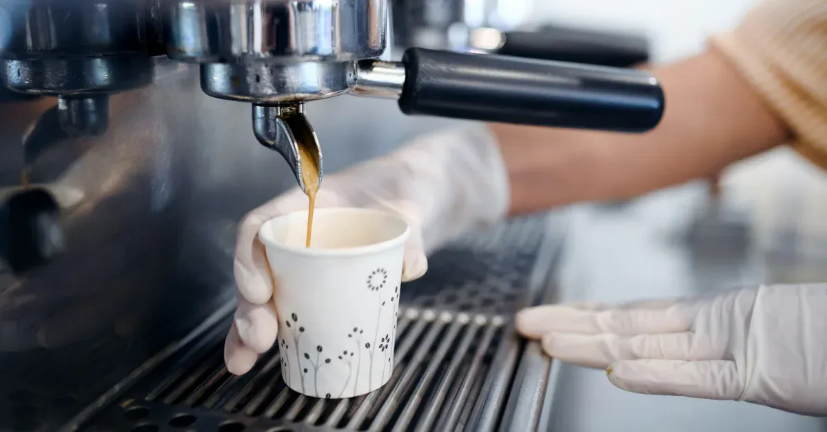 Espresso machine pouring into a to go cup