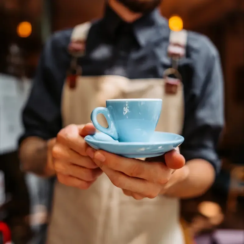 barista ending out an espresso