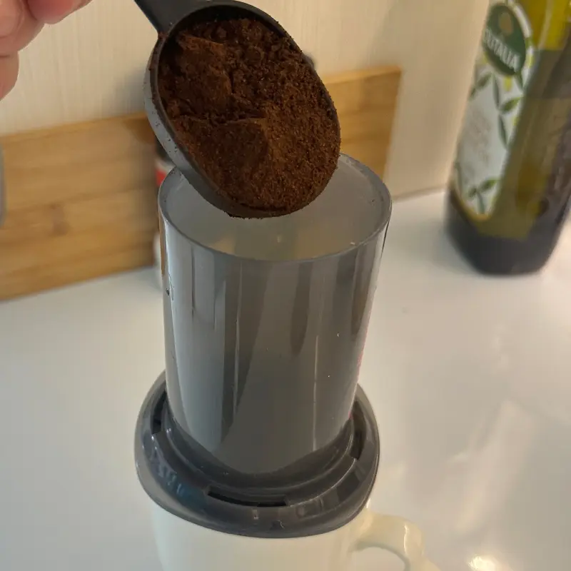Pouring grind into an Aeropress