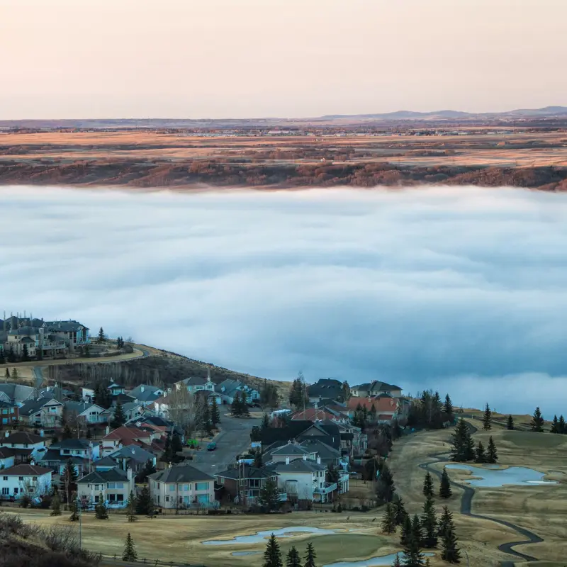 City of Cochrane under low clouds on a sunrise