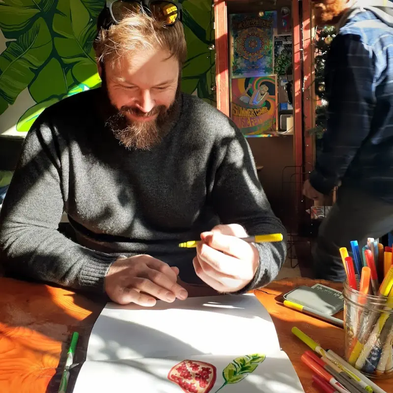 Blog Writer Leigh drawingin a coffeeshop that doesn't allow for wifi so people can talk to each other