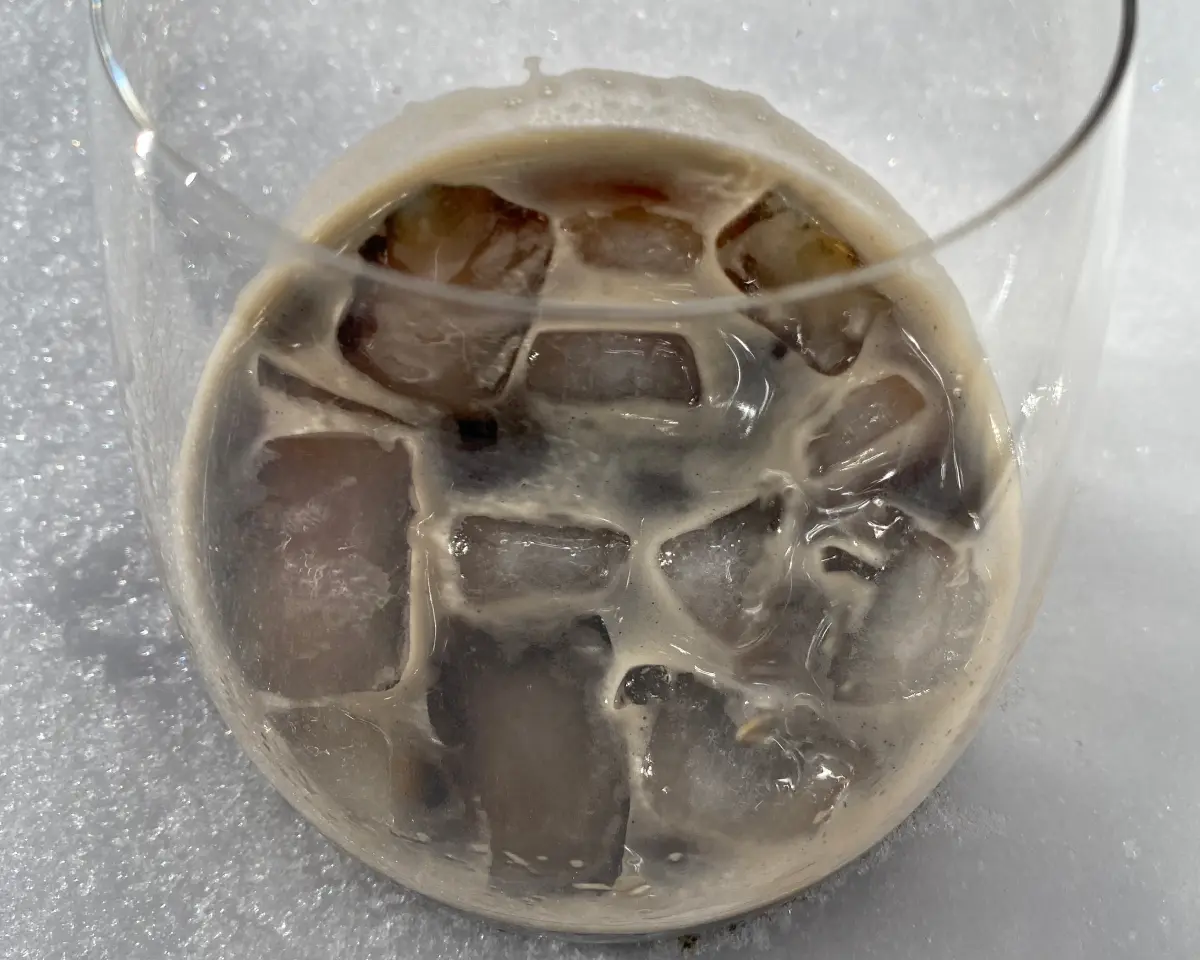 A glass of Nitro coffee in snow