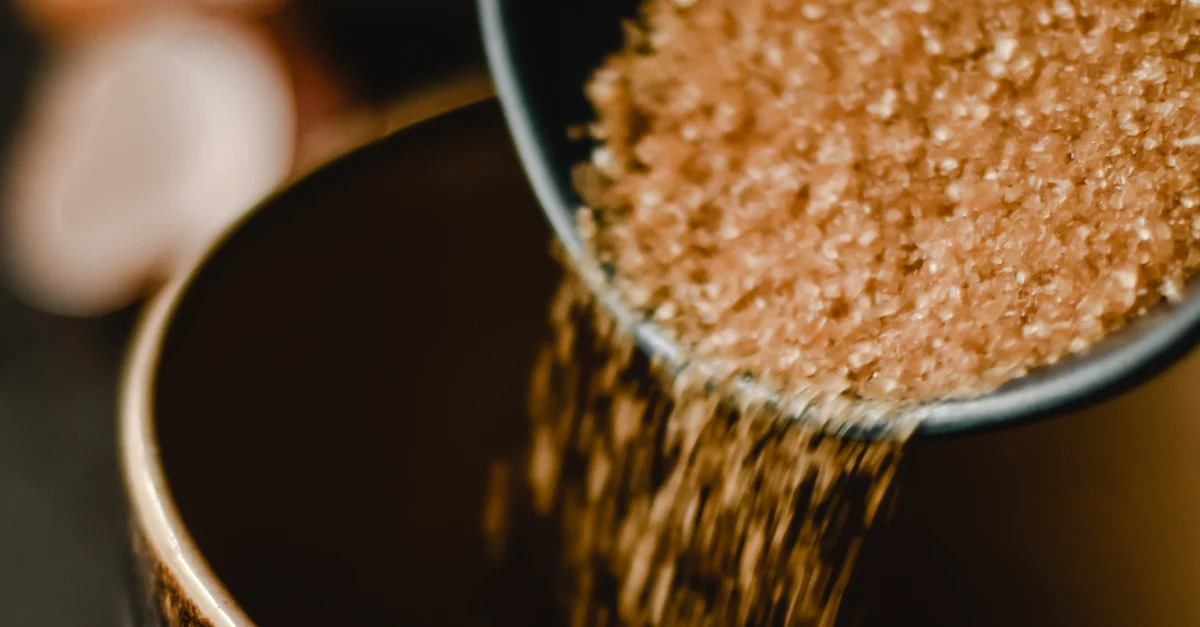 Pouring brown sugar from a bowl