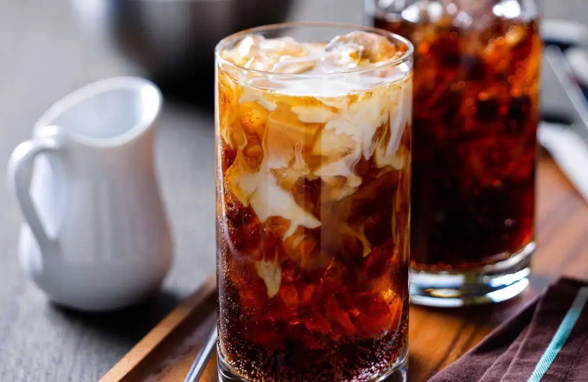 Creamer flowing into a cup of coffee