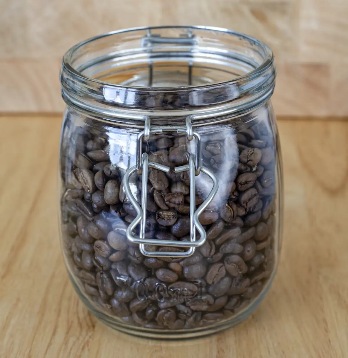 A glass jar with coffee beans in it