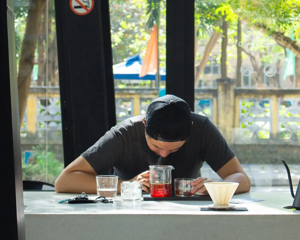 Young man enjoying the smell of his fresh dripped coffee