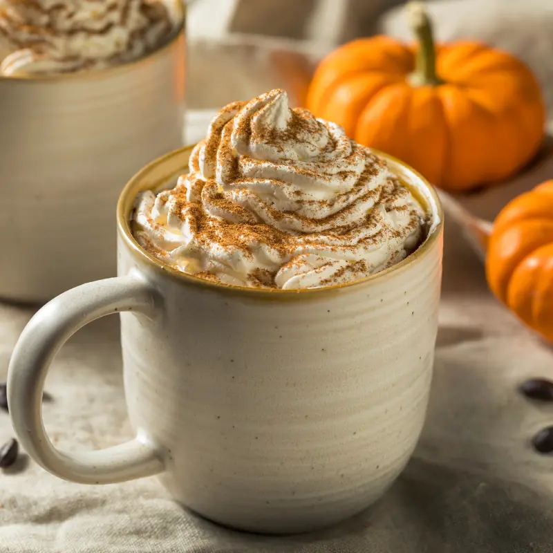 Pumpkin Spice Latte with pumpkins in the background