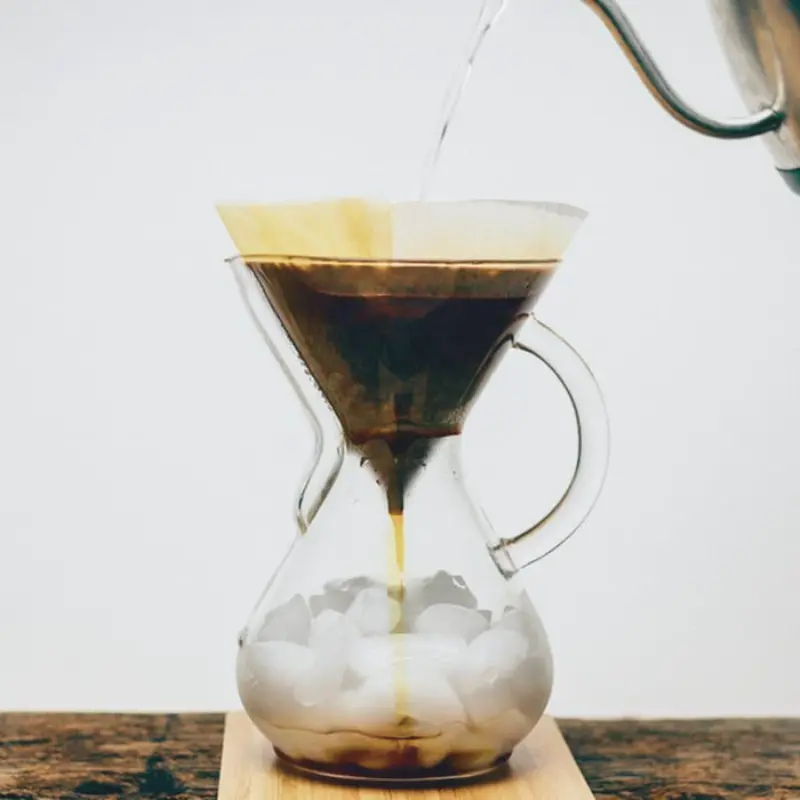Pouring into a pour-over maker with ice on the bottom