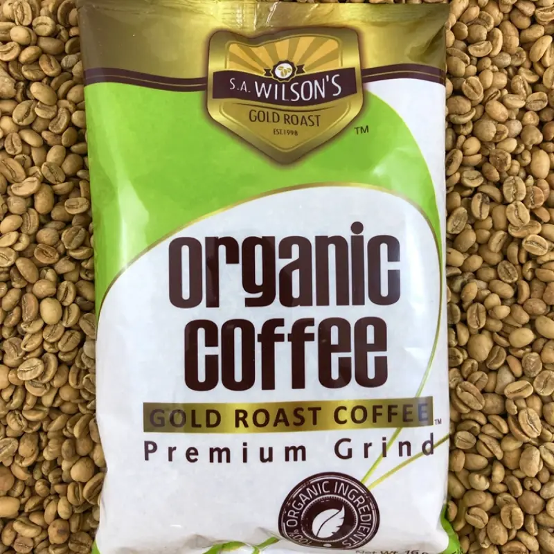 S.A. Wilson’s Gold Roast Bag on top of light roasted beans