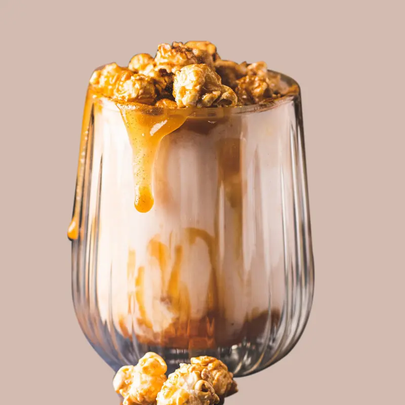 Latte covred with milk foam, caramel and popcorn