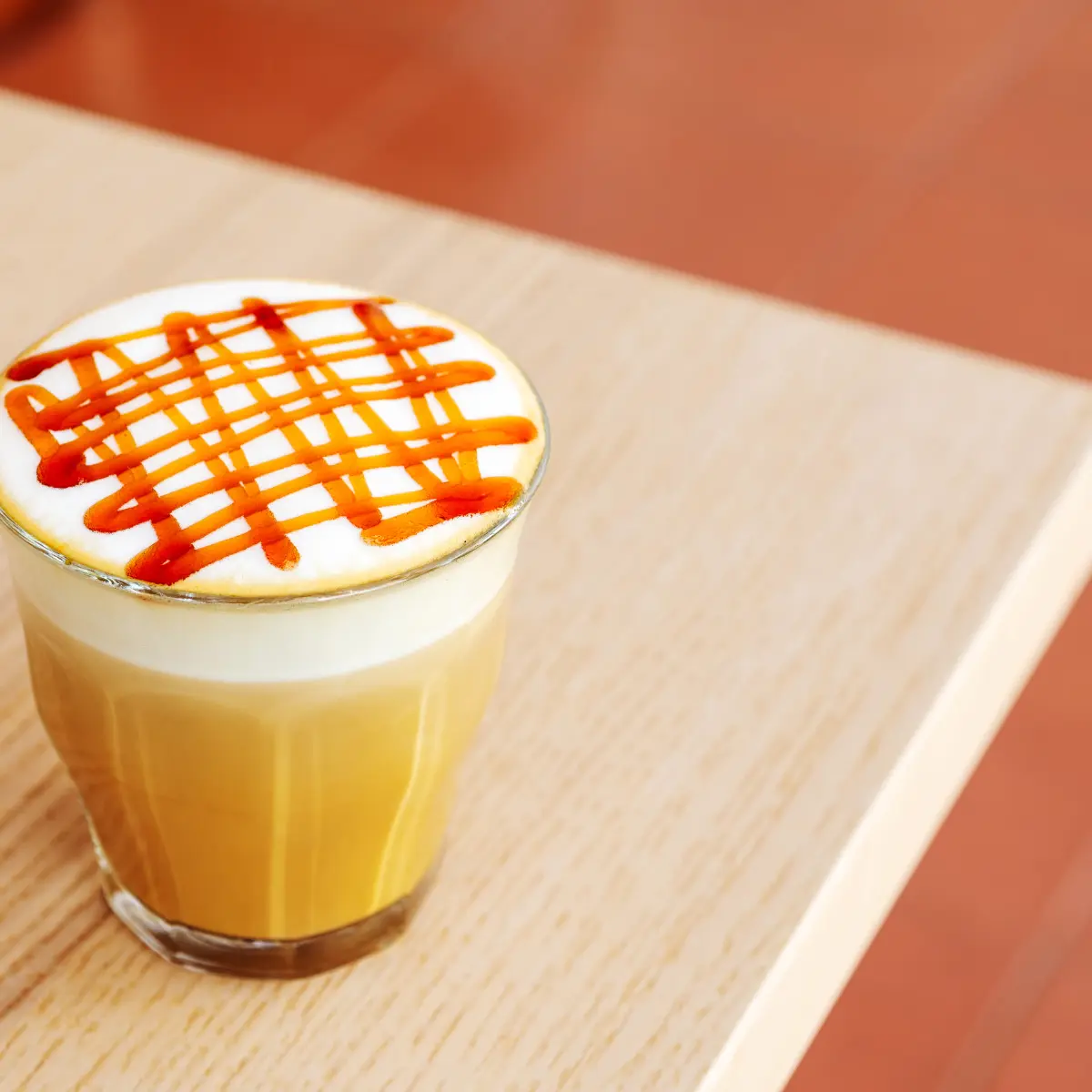 latte with syrup spread on top of the milk foam