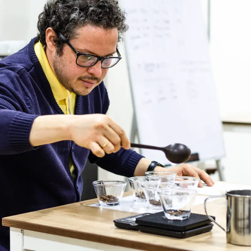 Man weighting coffee beans