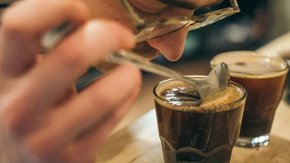 man smelling coffee